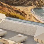Luxury sun loungers beside an infinity pool overlooking Kalo Livadi Bay at Four Seasons Hotel Mykonos