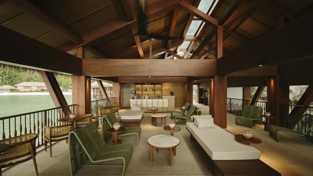 Open-air boathouse lounge at Lagen Island Resort in El Nido, Palawan, featuring timber architecture and views across the lagoon.