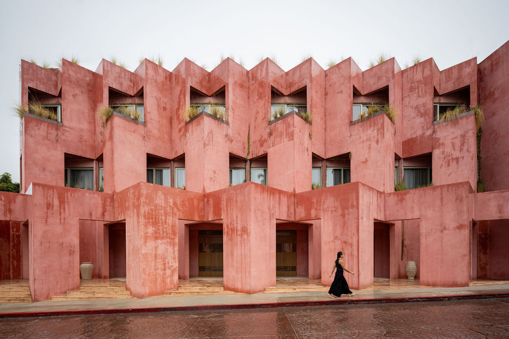 The Rosa Mexicano facade of Laiva Plaza hotel by RA! The repeated, receding, and overlapping handcrafted stucco walls follow the rhythm of papel picado, the Mexican folk art of intricately cut paper.