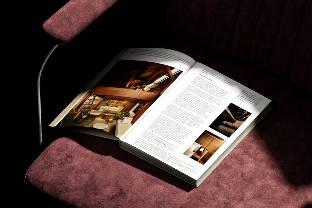 Open Wellness + Design Collection (WDC) hardcover book featuring WATG’s Lagen Island Resort hospitality design project in Palawan, Philippines, with architectural photography and editorial text, displayed on a burgundy chair.